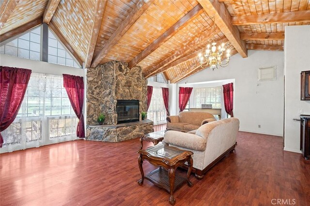 living room with an inviting chandelier, a stone fireplace, hardwood / wood-style flooring, vaulted ceiling with beams, and wood ceiling