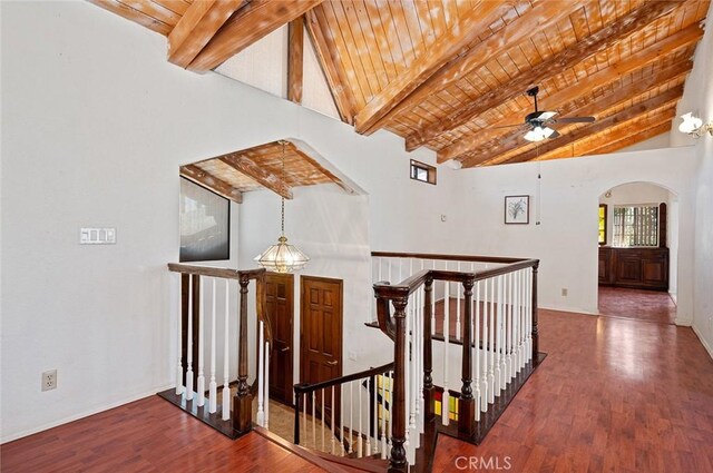 hallway with beamed ceiling, dark hardwood / wood-style flooring, and wood ceiling