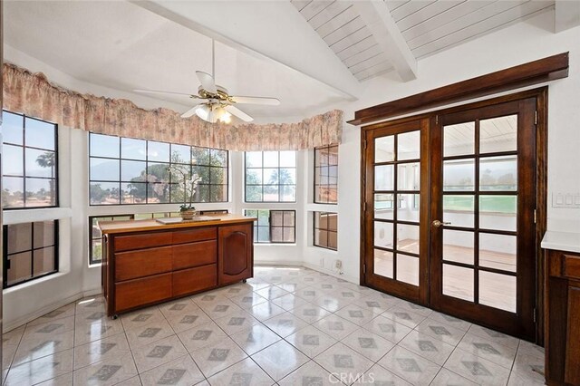 sunroom / solarium featuring vaulted ceiling with beams, ceiling fan, and french doors