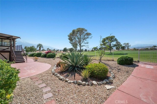 view of yard featuring a mountain view and a patio