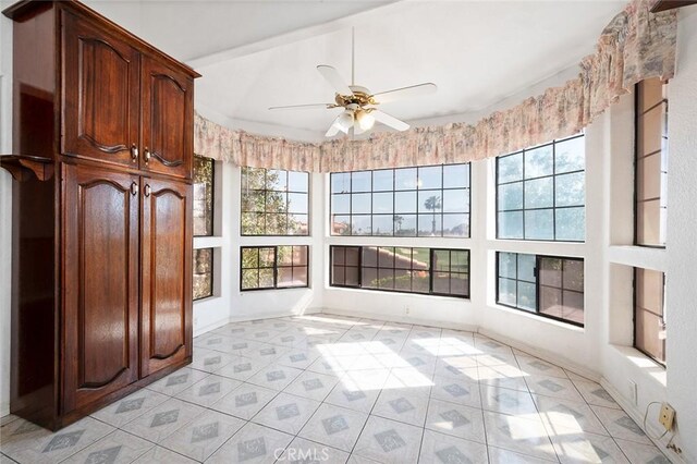 unfurnished sunroom featuring ceiling fan