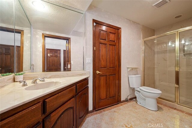 bathroom featuring tile patterned floors, vanity, an enclosed shower, and a textured ceiling