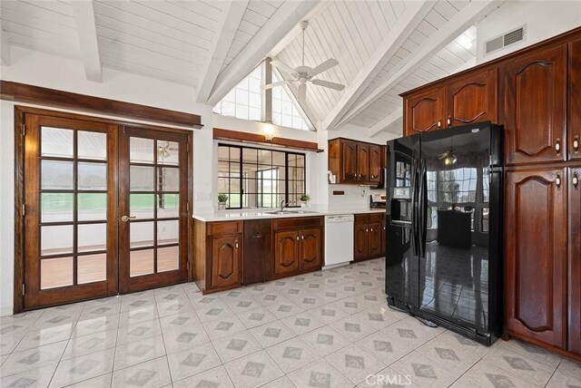 kitchen featuring ceiling fan, french doors, vaulted ceiling with beams, black refrigerator with ice dispenser, and white dishwasher