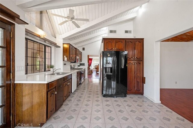 kitchen with black refrigerator with ice dispenser, sink, dishwasher, beamed ceiling, and stainless steel electric range