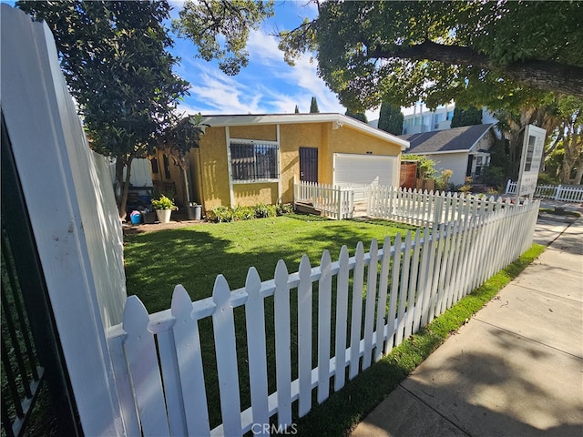 view of front of home with a front lawn and a garage