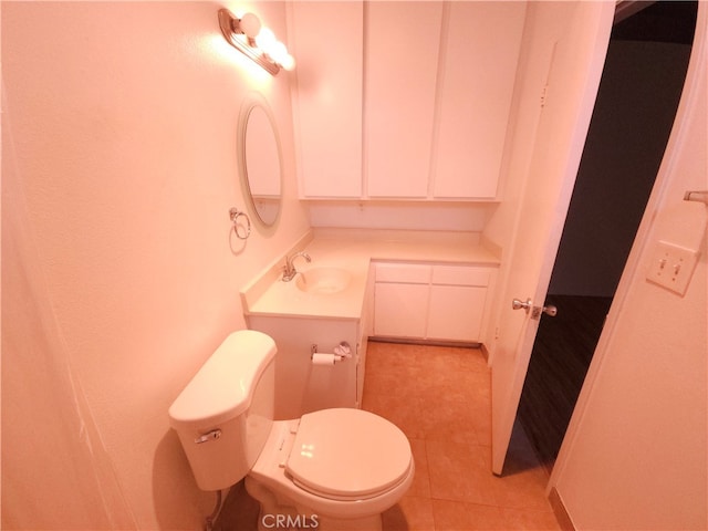 bathroom with vanity, toilet, and tile patterned flooring