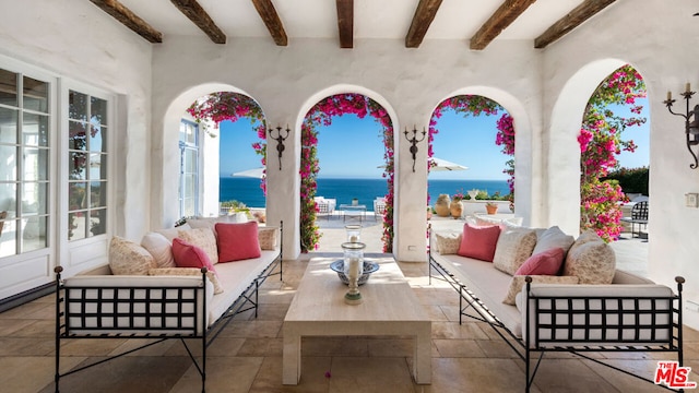 view of patio / terrace with a water view and an outdoor living space