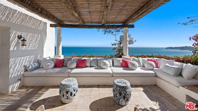 view of patio / terrace with a water view and an outdoor living space