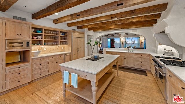 kitchen with light brown cabinetry, light hardwood / wood-style flooring, and stainless steel appliances