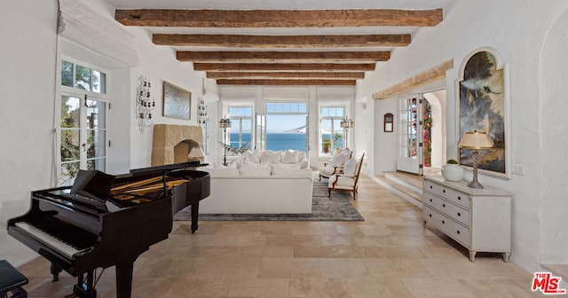 living room with beamed ceiling, plenty of natural light, and a water view