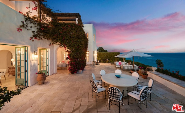 patio terrace at dusk with a water view