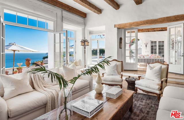 living room featuring french doors, beam ceiling, a water view, and hardwood / wood-style flooring