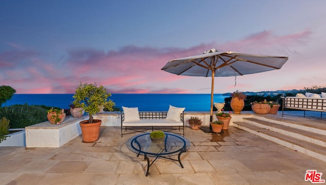 patio terrace at dusk with a water view