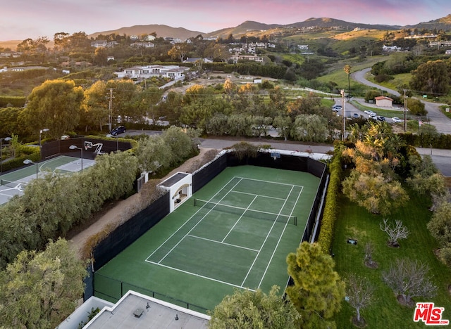 aerial view at dusk featuring a mountain view