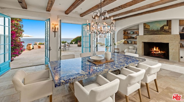 tiled dining space featuring a water view, a high end fireplace, beam ceiling, french doors, and an inviting chandelier