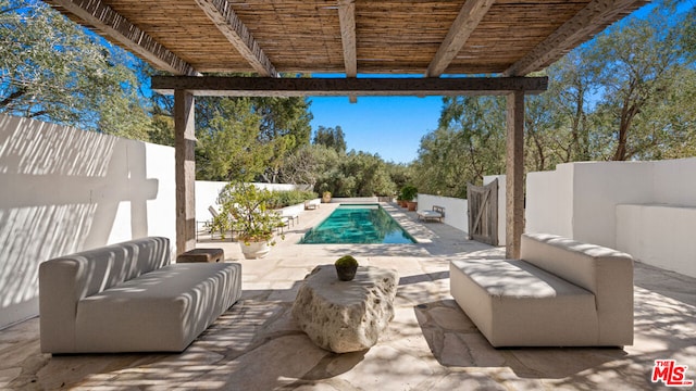 view of terrace with outdoor lounge area and a fenced in pool