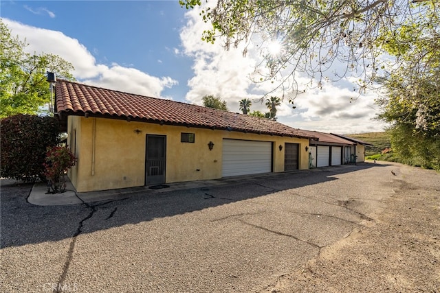 view of home's exterior with an outdoor structure and a garage