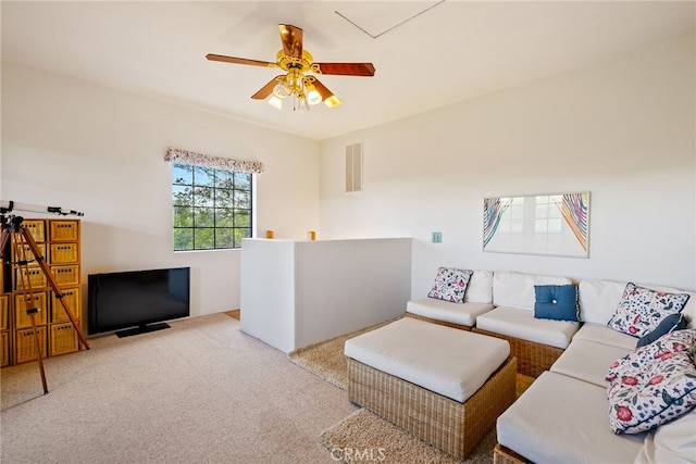 carpeted living room with ceiling fan