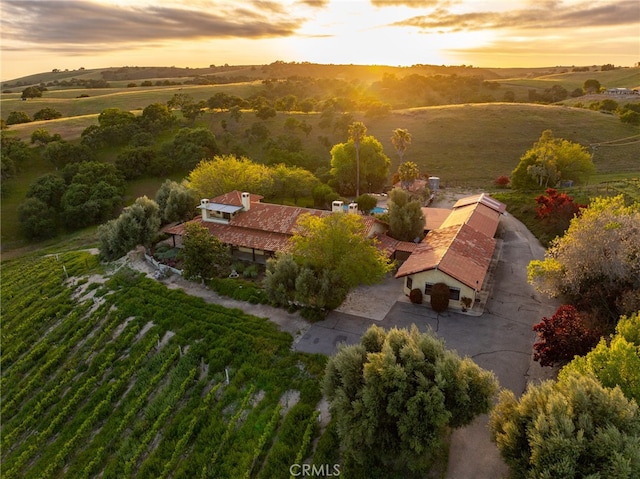 aerial view at dusk featuring a rural view