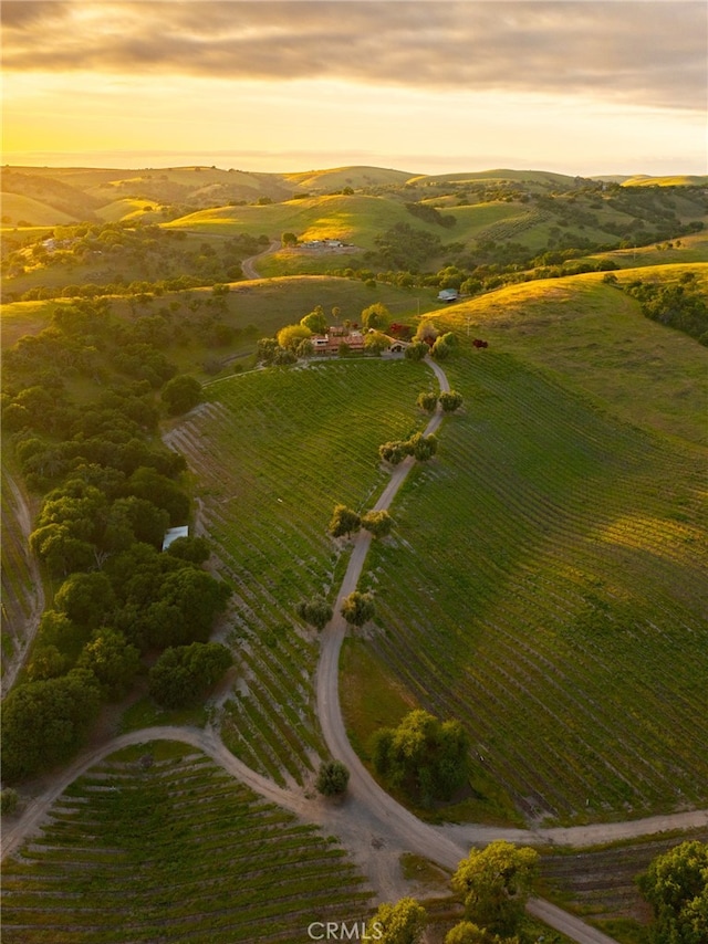 aerial view at dusk featuring a rural view