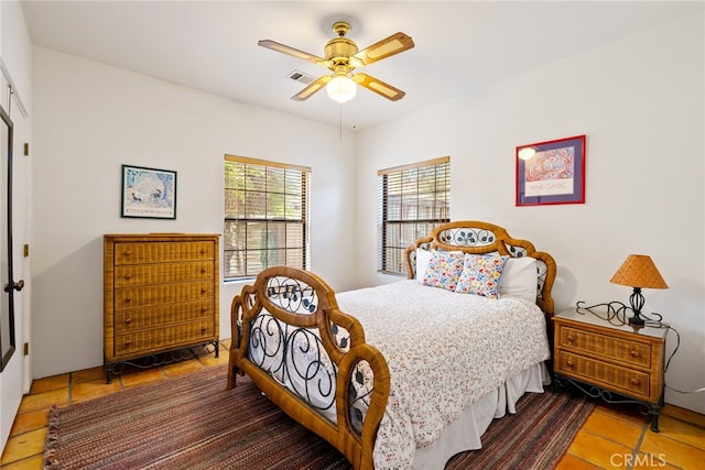 tiled bedroom with ceiling fan