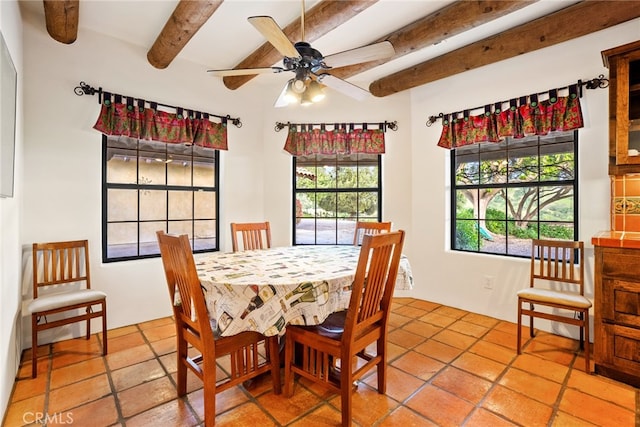 tiled dining space featuring beamed ceiling and ceiling fan