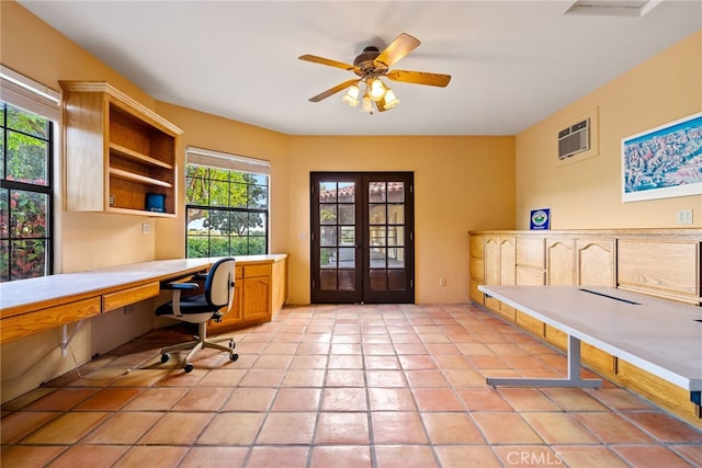 office featuring light tile floors, built in desk, ceiling fan, and french doors