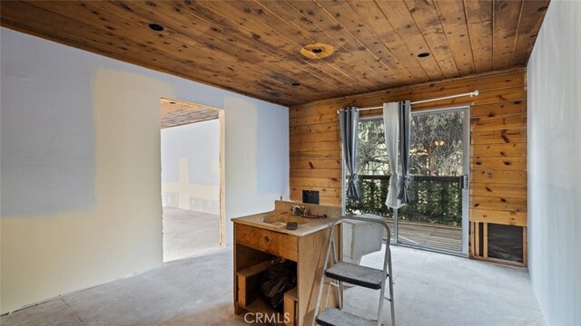 dining room with wood ceiling and wooden walls