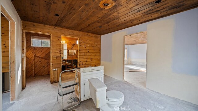 bathroom featuring wood ceiling and wood walls