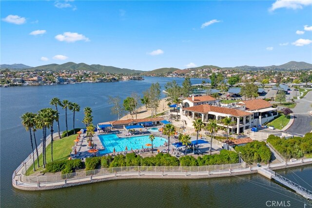 birds eye view of property with a water and mountain view