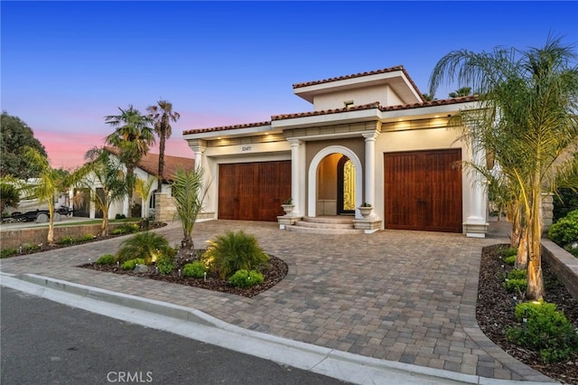 mediterranean / spanish-style house with a garage