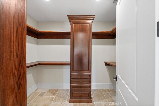 spacious closet featuring light tile flooring