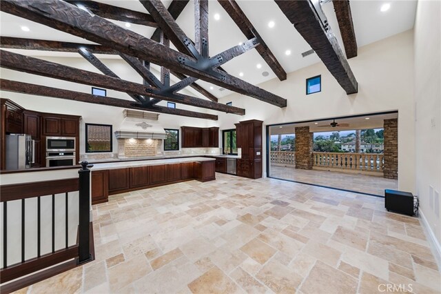 kitchen featuring premium range hood, high vaulted ceiling, beamed ceiling, appliances with stainless steel finishes, and light tile floors