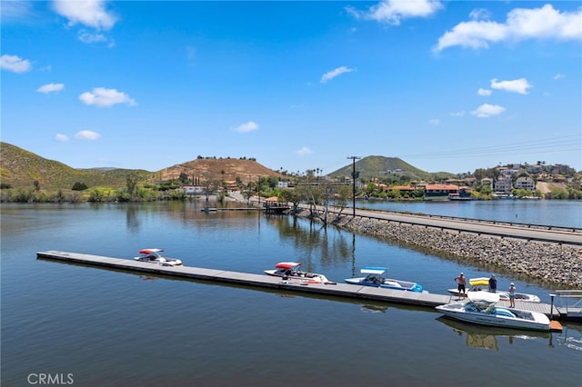 view of dock featuring a water and mountain view