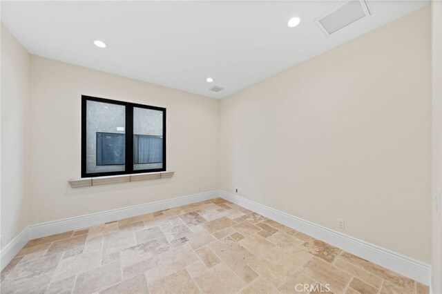 unfurnished room featuring light tile floors