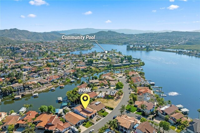 birds eye view of property featuring a water and mountain view