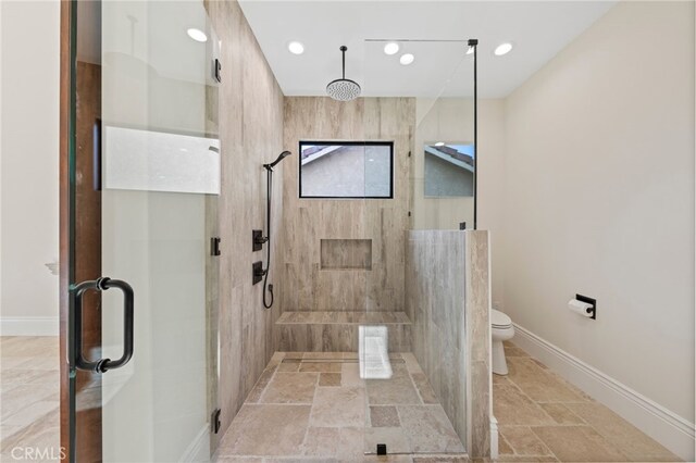 bathroom featuring a shower with door, toilet, and tile flooring