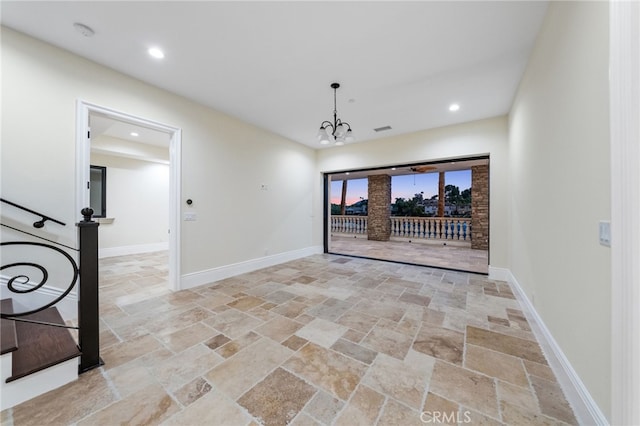 tiled empty room featuring a notable chandelier