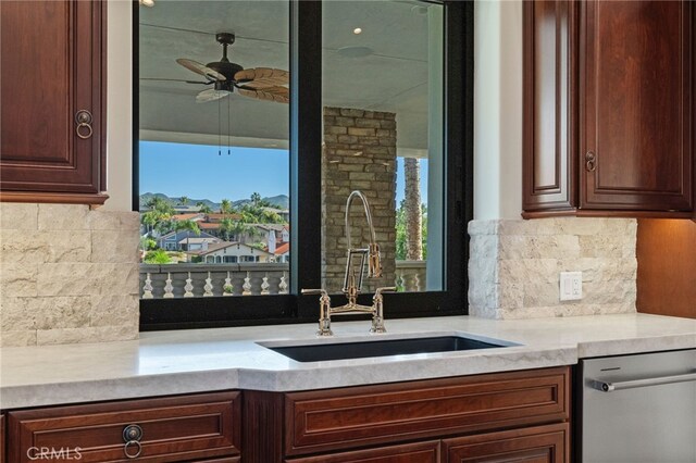 kitchen featuring backsplash, sink, ceiling fan, and stainless steel dishwasher