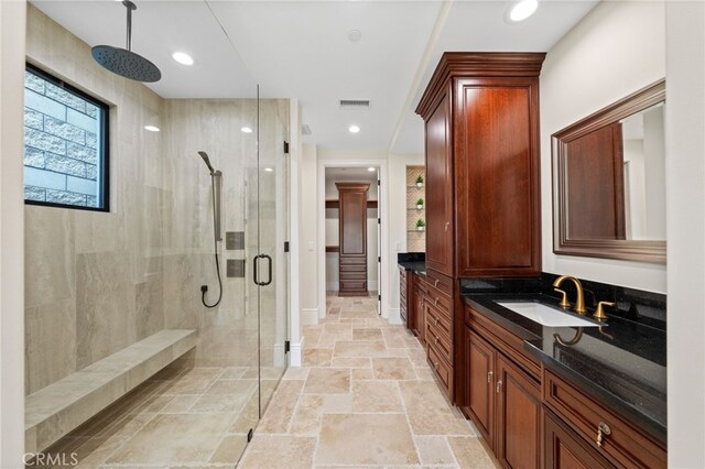 bathroom featuring walk in shower, vanity, and tile floors