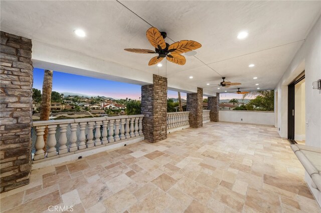 patio terrace at dusk featuring ceiling fan