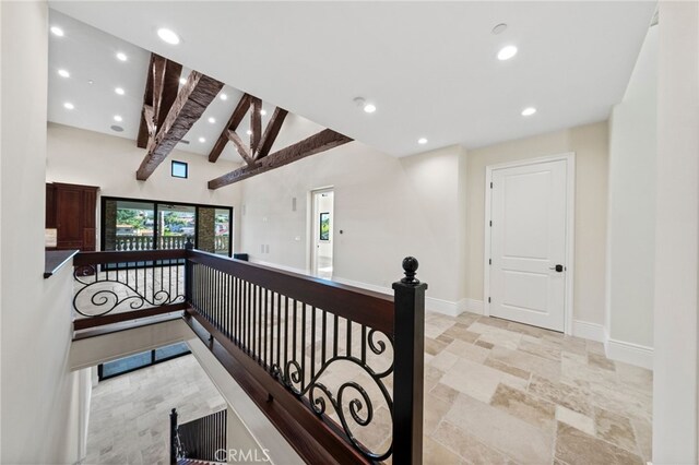 hallway with beamed ceiling, high vaulted ceiling, and light tile flooring