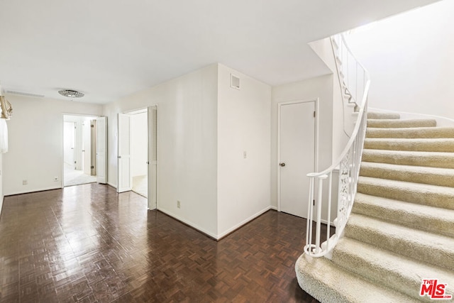 interior space featuring dark parquet flooring