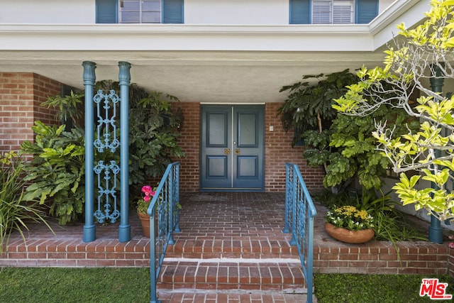 view of exterior entry with covered porch