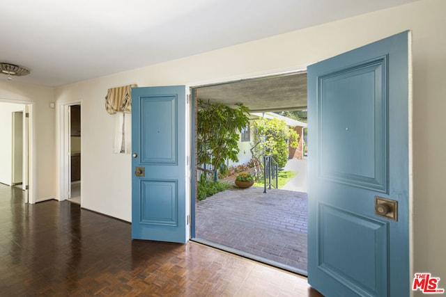 entryway featuring dark parquet flooring