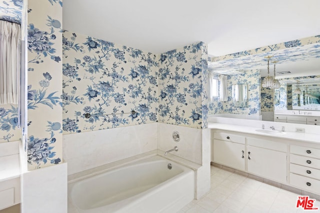 bathroom featuring tile patterned flooring, vanity, and a bath