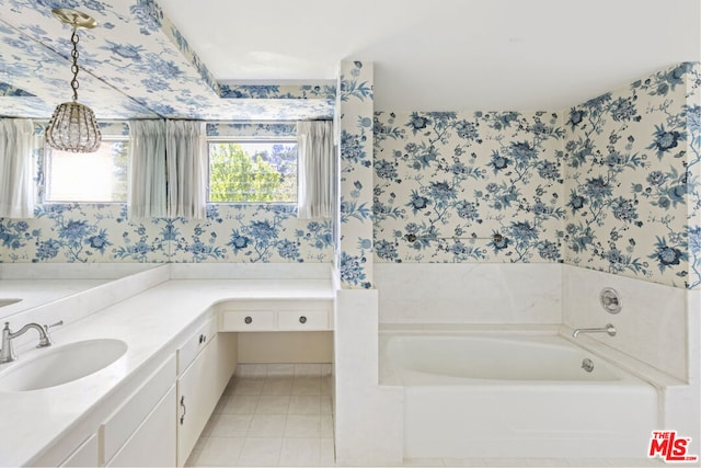 bathroom featuring vanity, a wealth of natural light, and a bathing tub