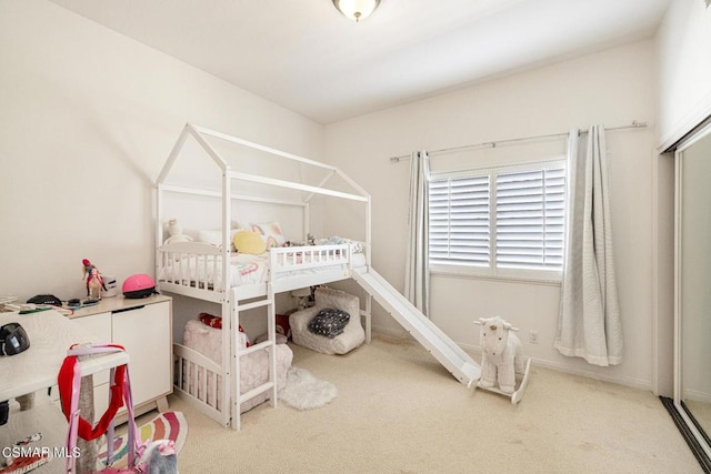 carpeted bedroom featuring a crib