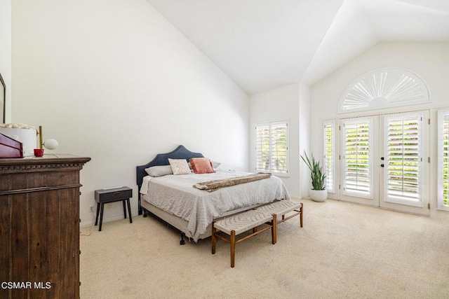 carpeted bedroom featuring access to outside, french doors, and vaulted ceiling