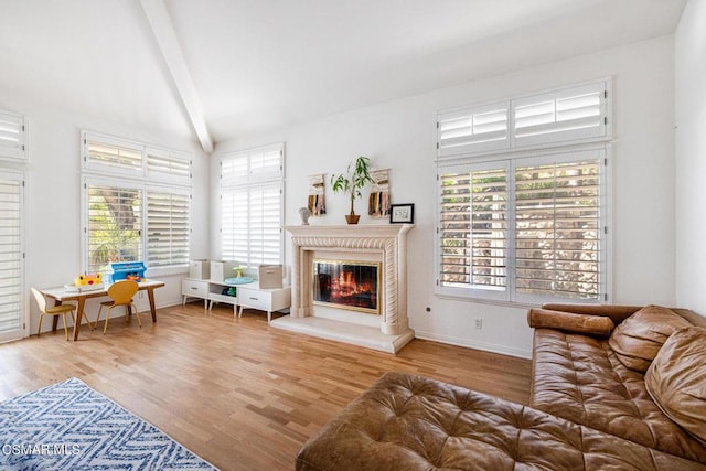 living room featuring light hardwood / wood-style flooring and beamed ceiling